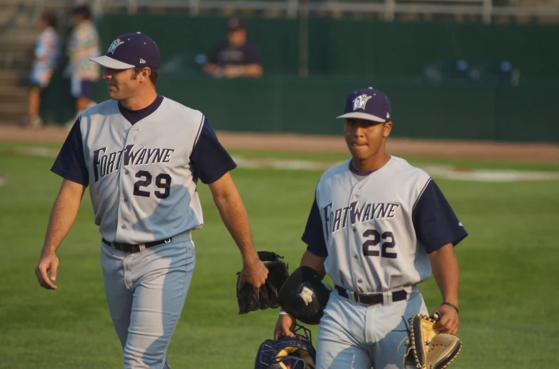 two baseball players walking out on a field together