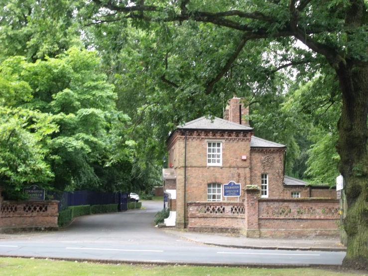 a road with an old brick building in the middle