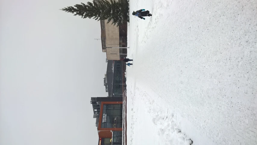 there is people standing at a beach with a snow covered shoreline