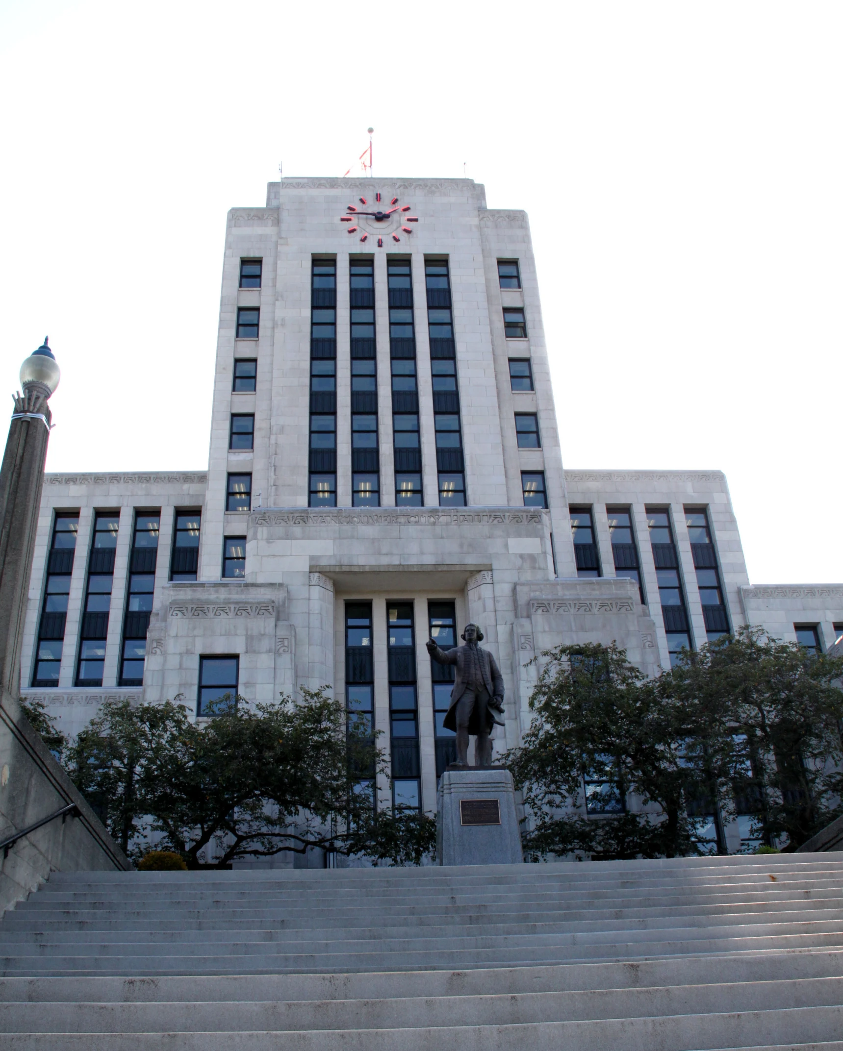 the building in front of it is tall with stairs going up to the top