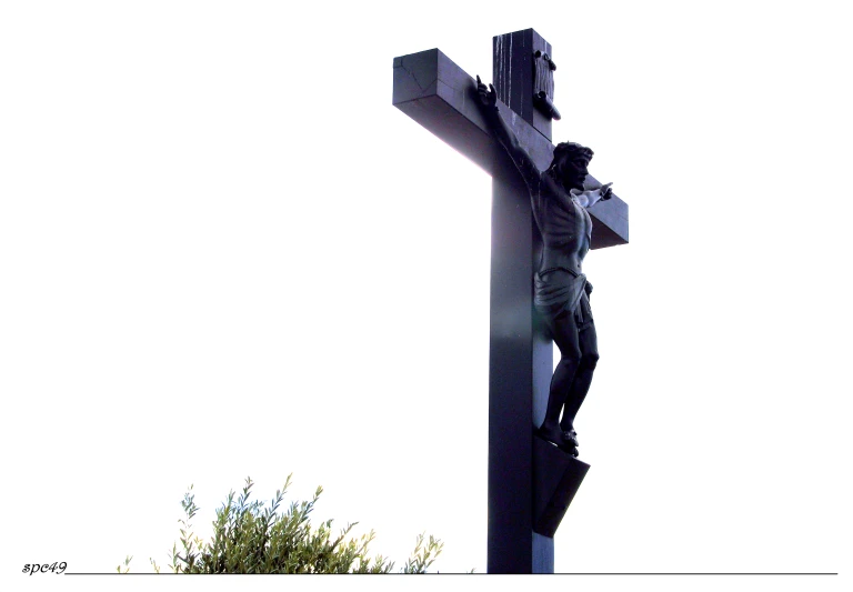 silhouette of a person high up on a cross