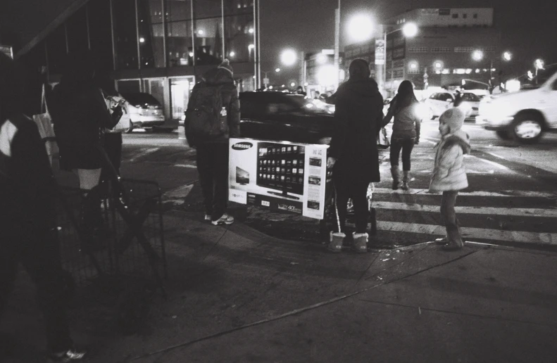 a black and white po of some people waiting for a bus