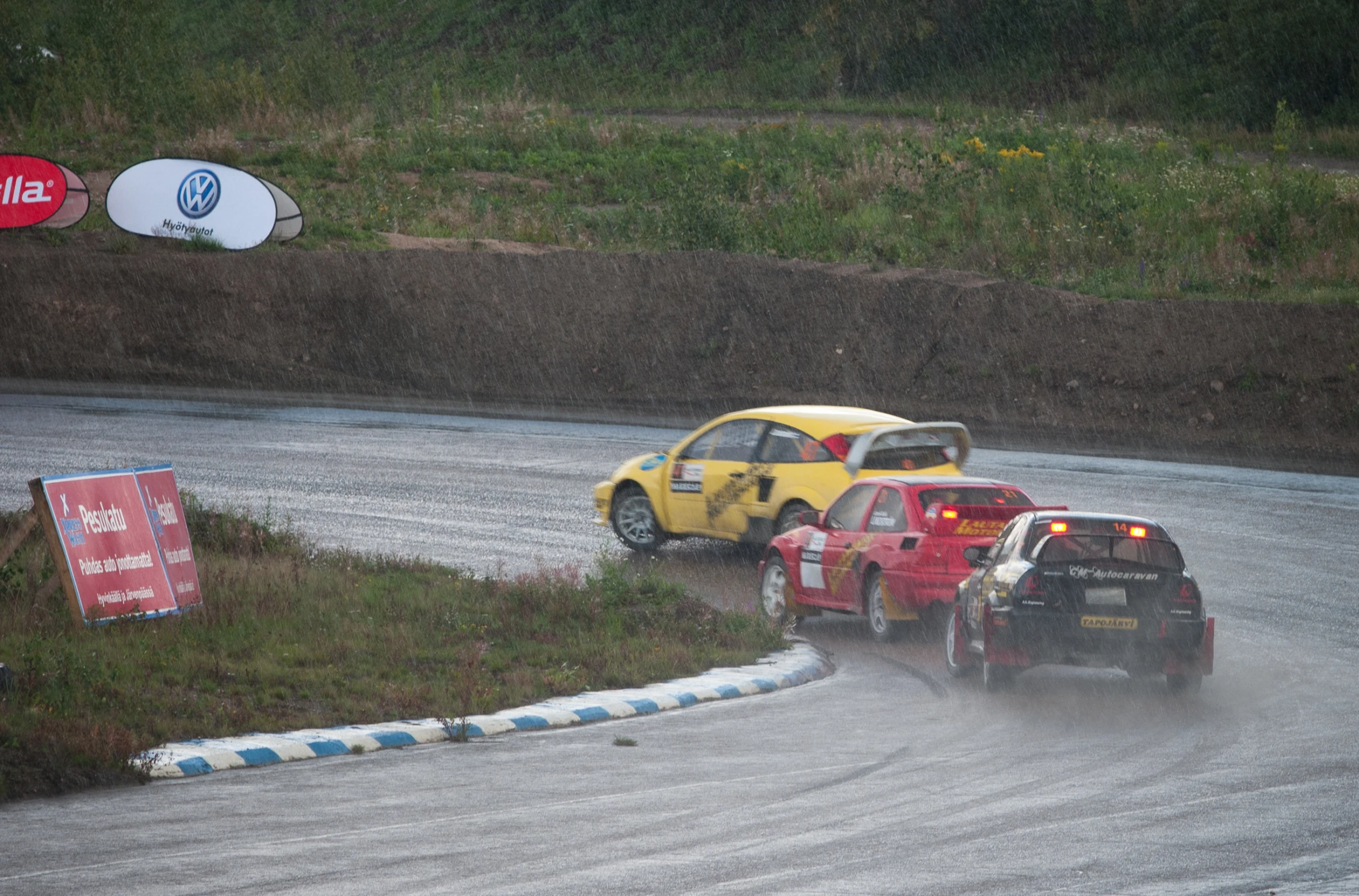 two cars going around a turn on the track during a race