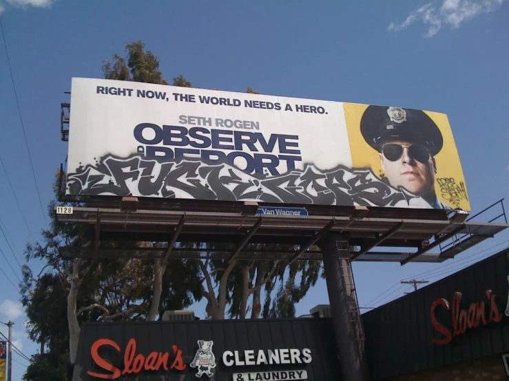 billboard showing john hurtts movie poster and words on street