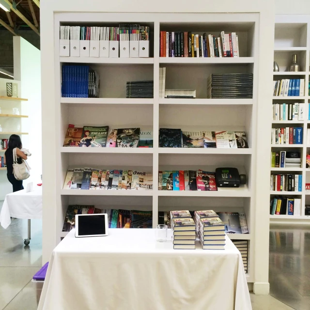 some people in front of a bookshelf in a liry