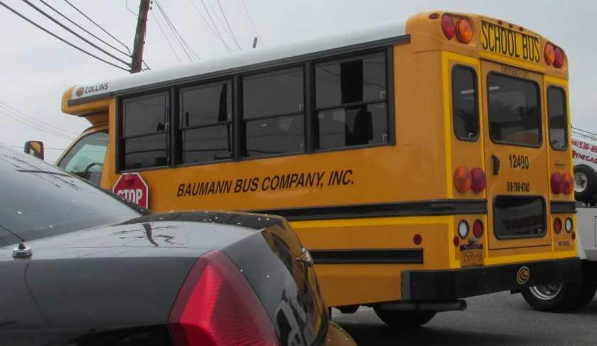 two yellow buses are next to each other