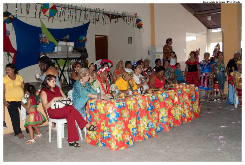 people in costumes sitting at tables with clowns