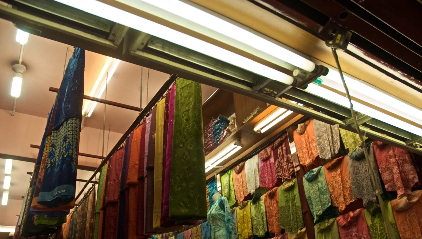 a store with colorful scarfs in rows