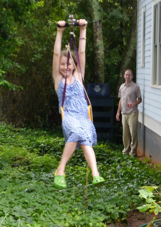 a person hanging off of a small rope