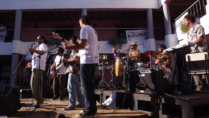 a group of people standing around playing instruments