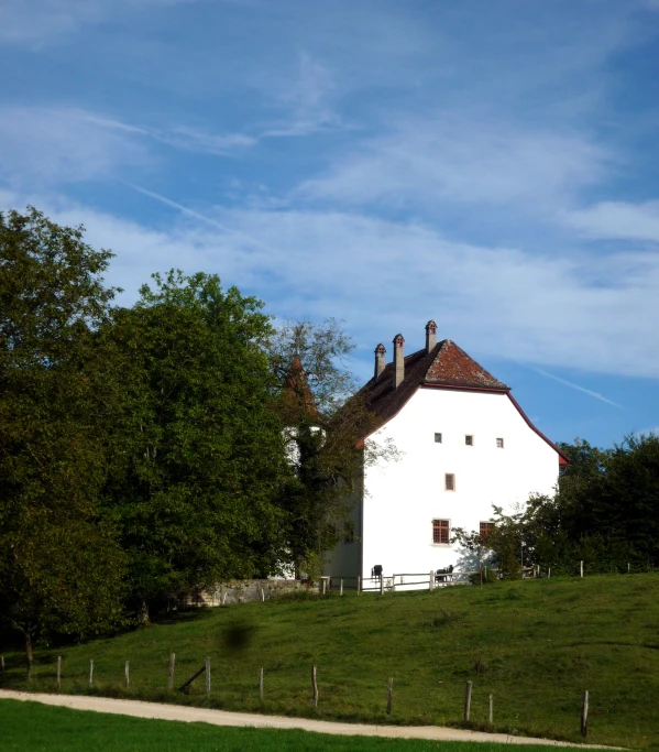 a tall white building sitting on the side of a hill