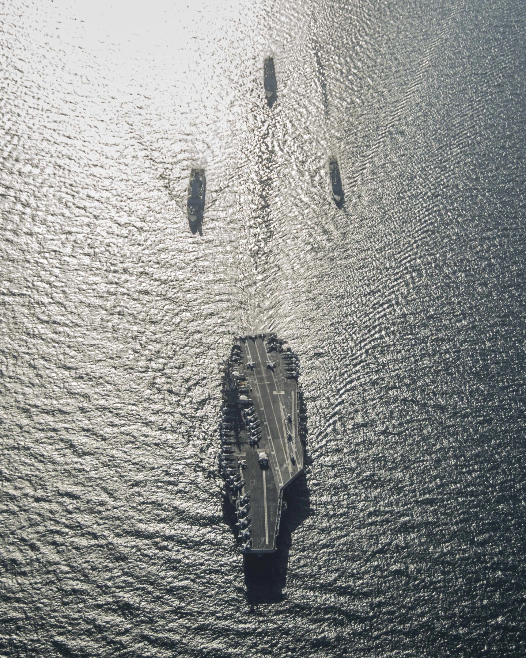 a large naval ship floating in the middle of water