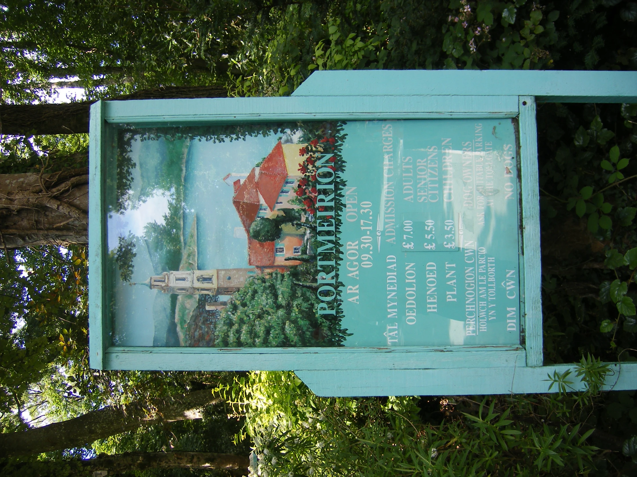 a sign with a picture on it near trees