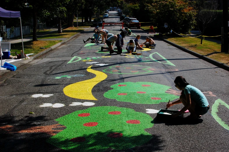 children chalk art on the ground at a park