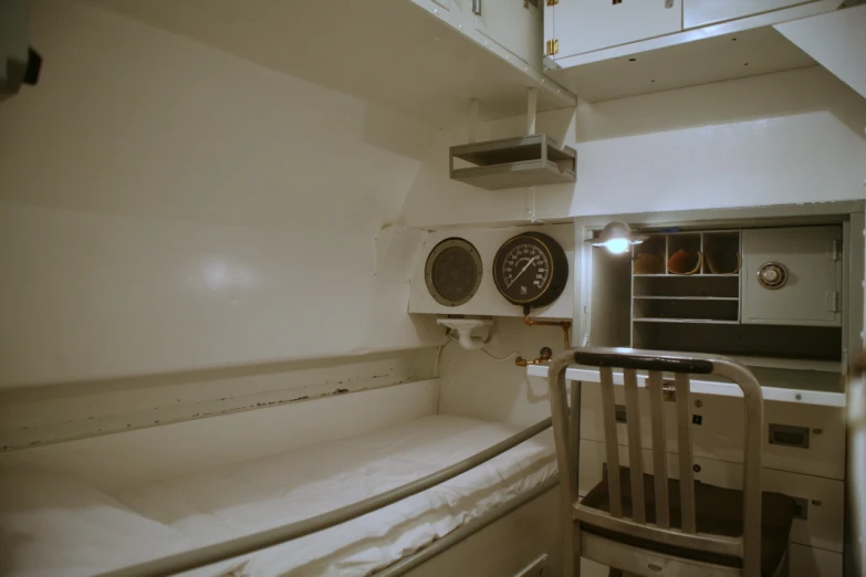 an empty small room with two clocks mounted to the wall