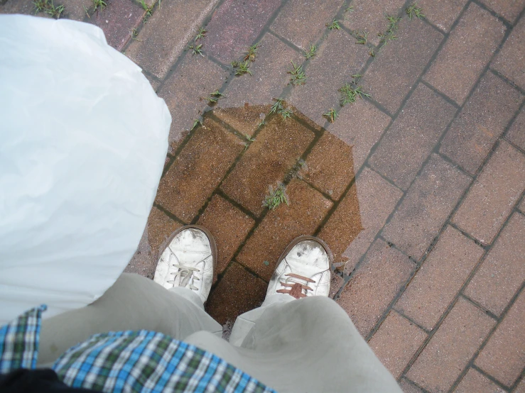 someone is wearing a white umbrella and blue plaid pants