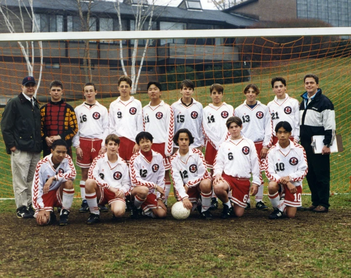 a soccer team on a field next to the goal