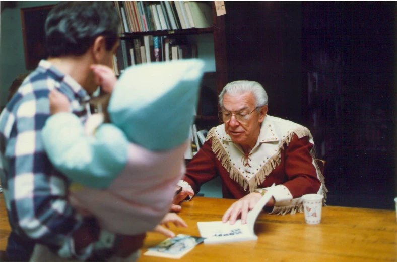 an older man playing with his grandfather in the living room