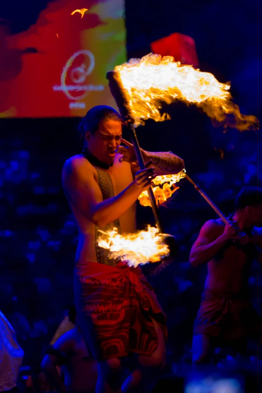 the fire breather is at an event in front of people