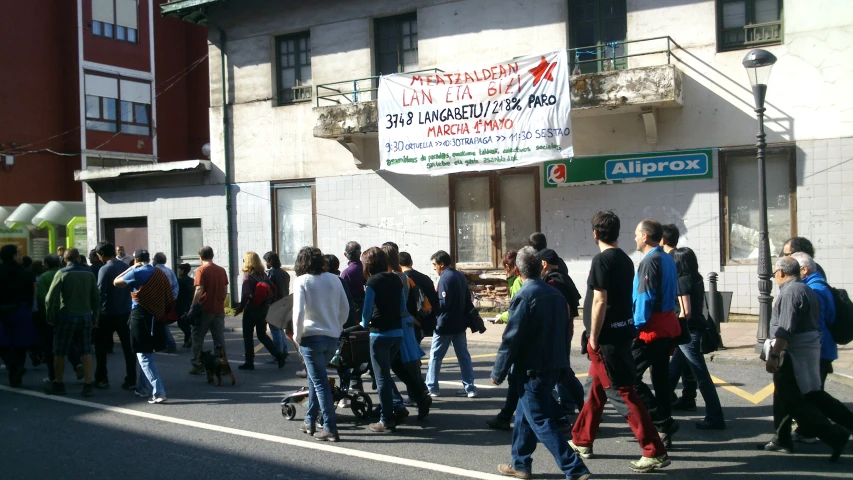 a crowd of people walking in the street