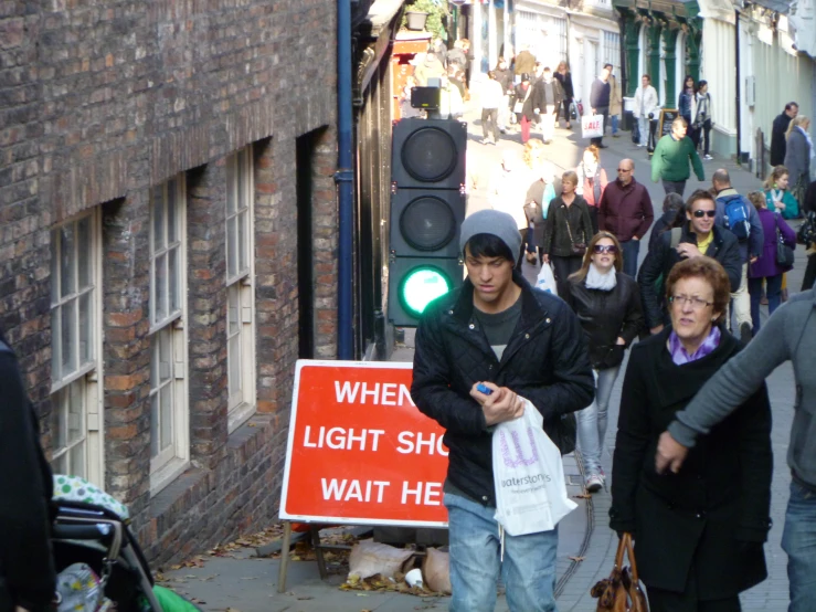 a group of people are standing on a street