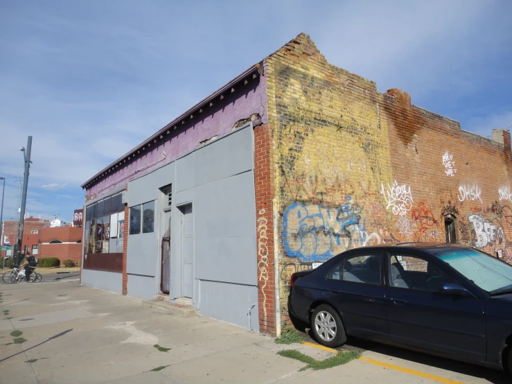 there is a car parked next to an old building