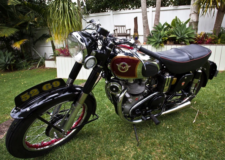 a close up of a parked motorcycle on the grass