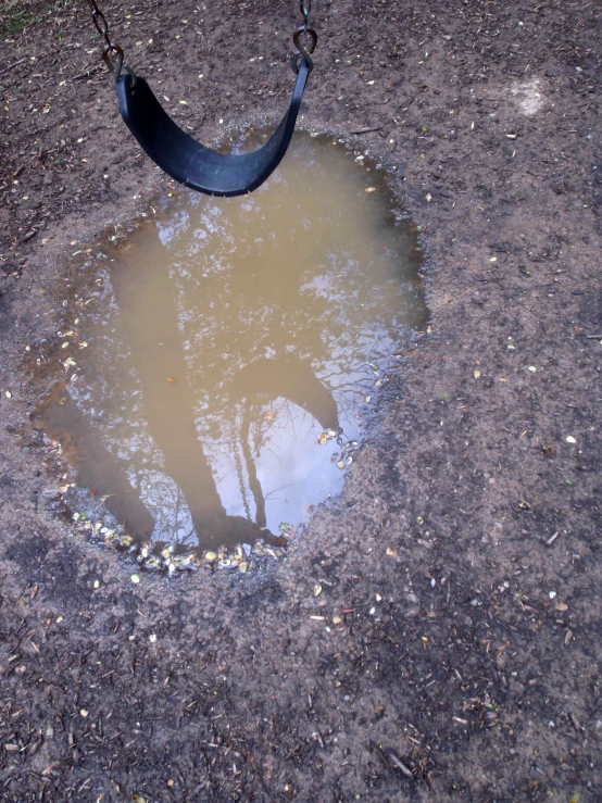 a child swing with a reflection of an umbrella hanging upside down