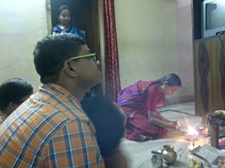 people sitting around a table with plates and cake on it