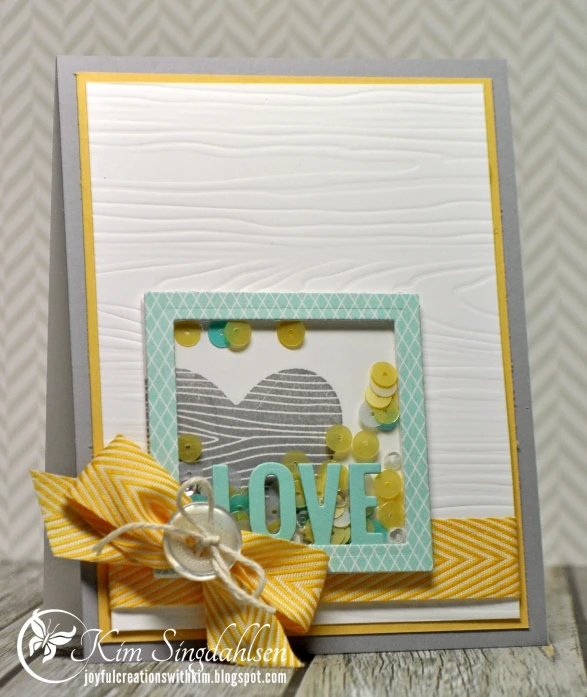 a handmade scrapbook with a bow and a card that reads love