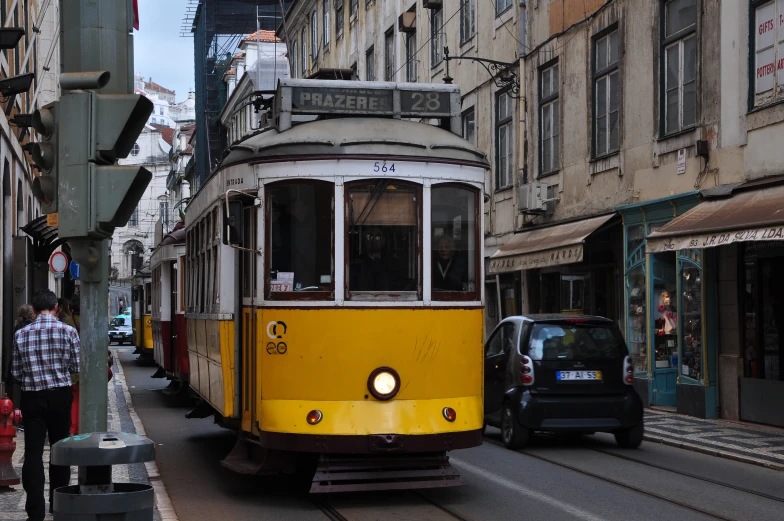 an old style trolly going down a city street