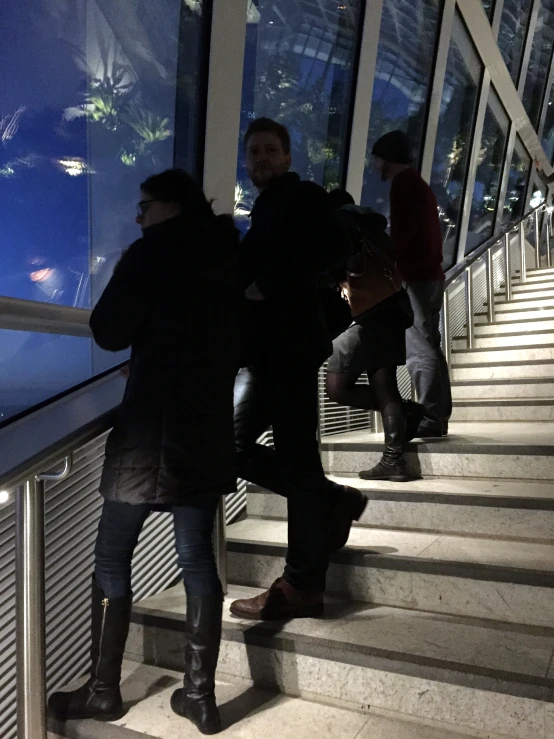 people are walking down some stairs at night