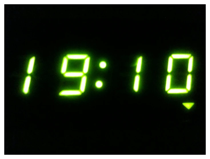 two clocks that say 6 9 pm in green glowing numbers