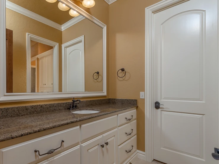 a nice bathroom with granite counter top and two sinks