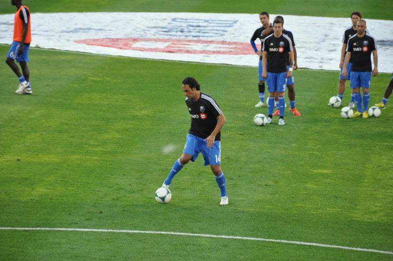 a man standing on a soccer field with a soccer ball