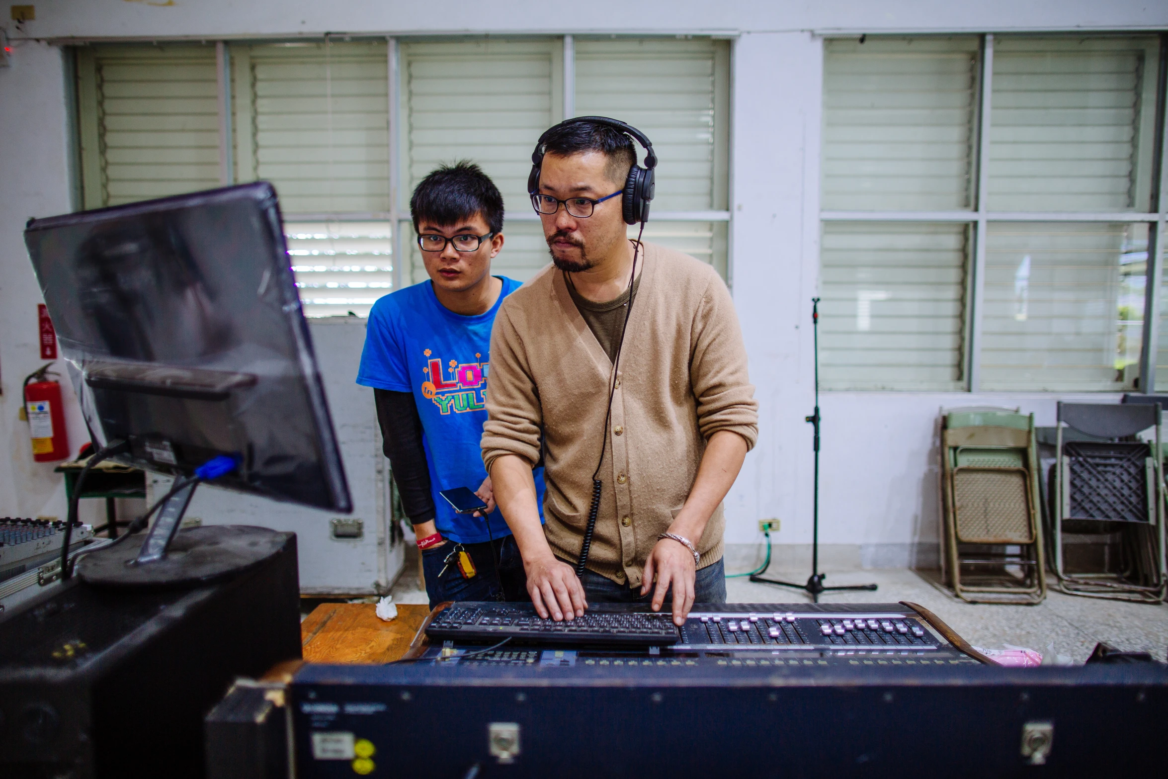 a couple of guys that are standing around some equipment