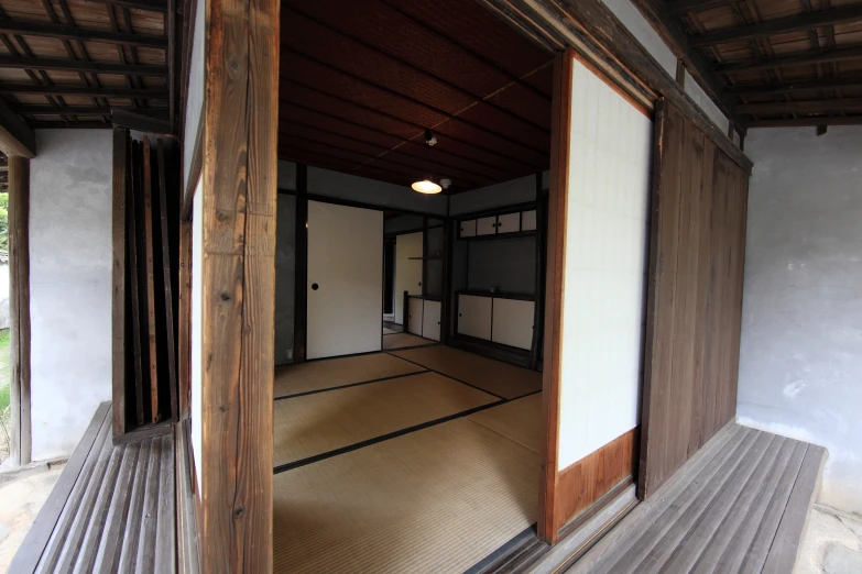 an empty room with wood panels and white walls