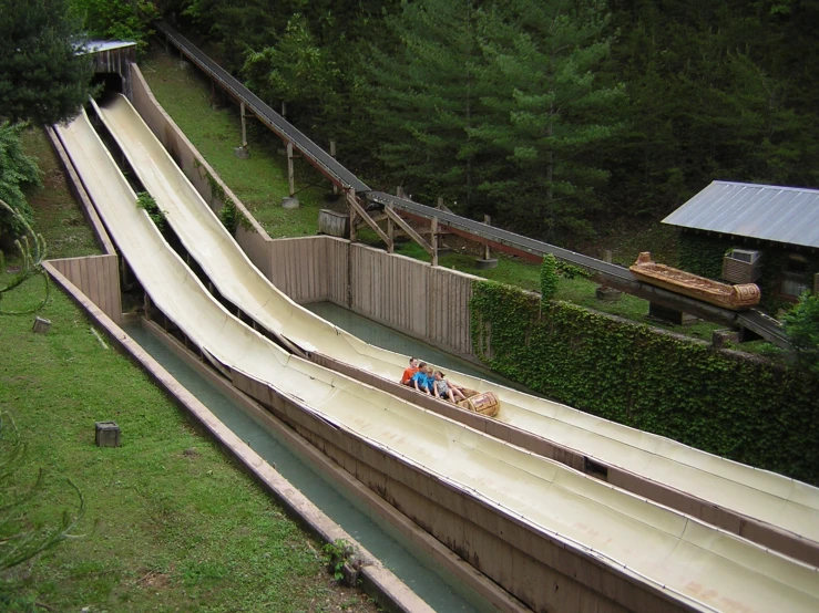 a boy is riding on the side of a slide