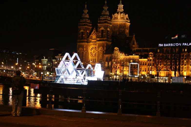 a group of buildings lit up with lights in the night