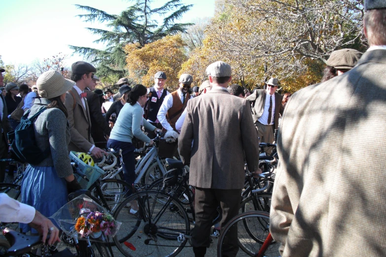 a bunch of people that are standing with bikes