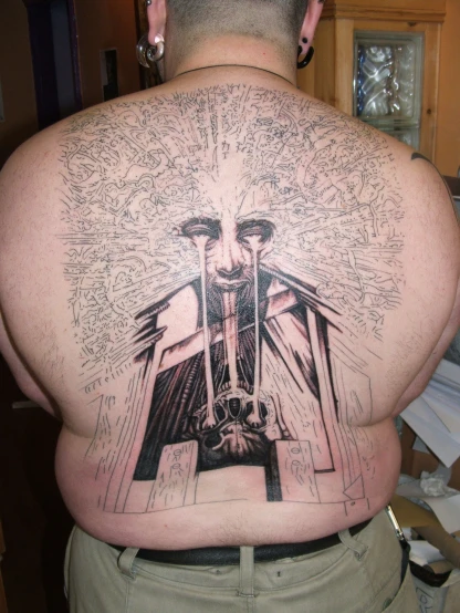 this is a man with a tattoo on his back