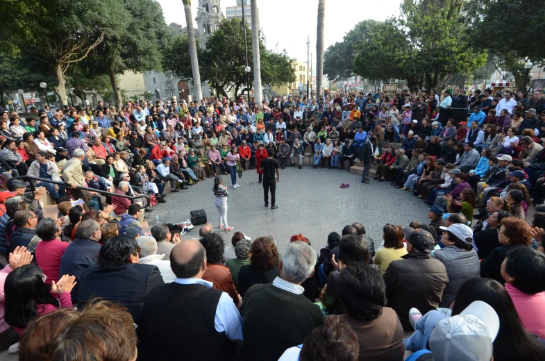 a man standing on top of a circle surrounded by people