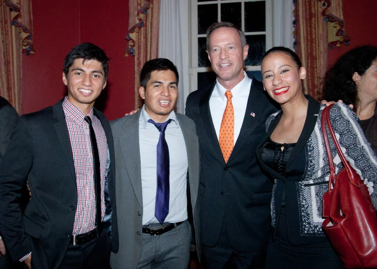 a group of four men and women standing next to each other