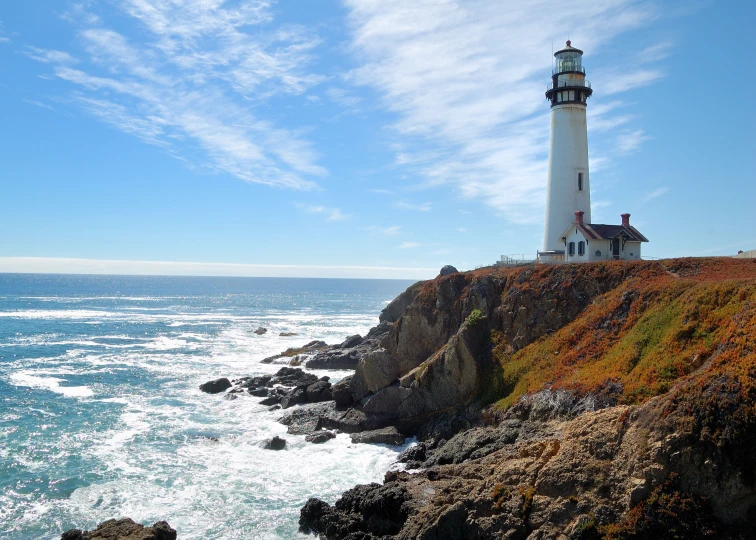 the lighthouse overlooks the water at an ocean - side island