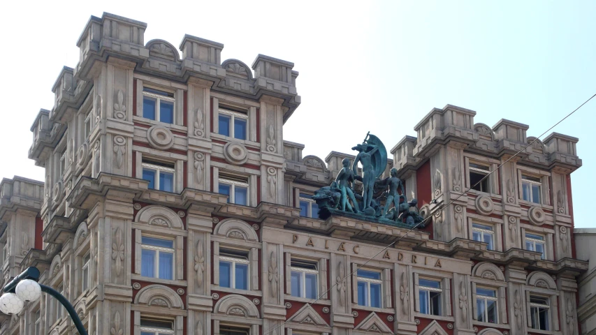 an old building that has a statue on top