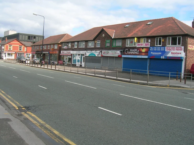 buildings and shops on an empty road in a town