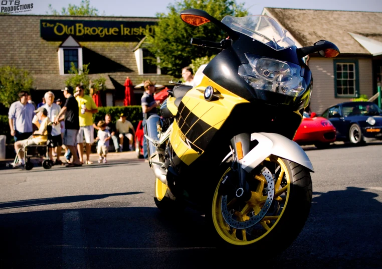 a yellow and black motorcycle parked next to a building