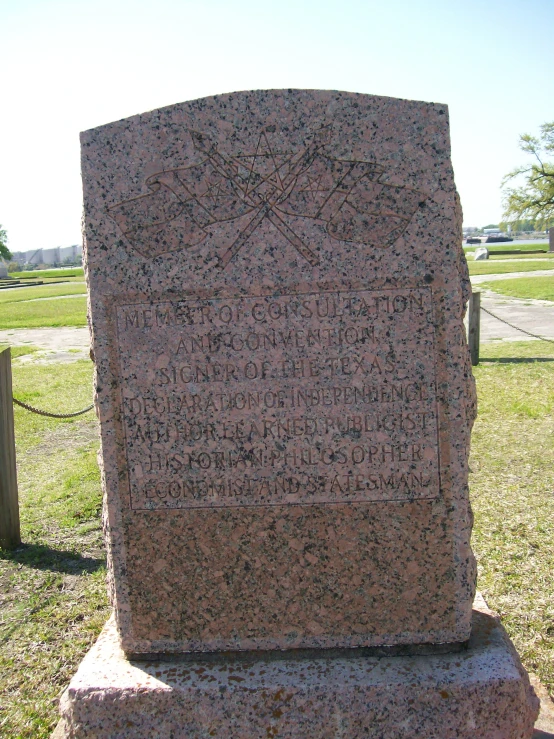 a monument with two crosses is next to a fence