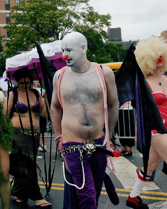 a group of men walking down a street wearing costumes