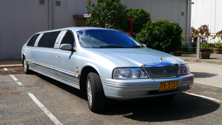 a silver car parked in front of a building